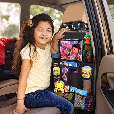 Child sitting in a car with a backseat organizer displaying toys and snacks.