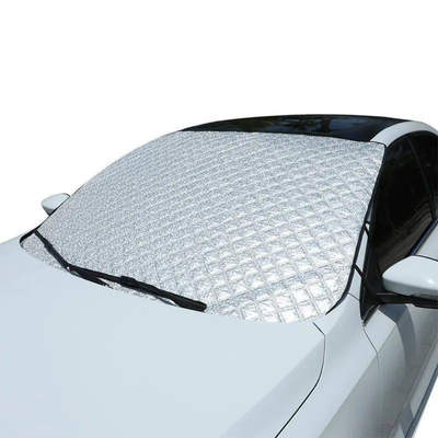 Car windshield covered with a snowflake patterned sunshade on a white background